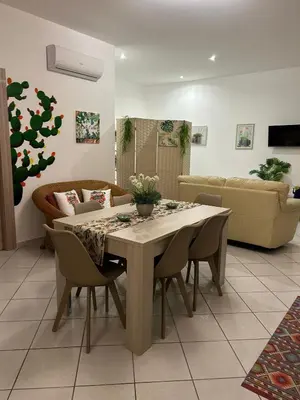 a living room with a table and a couch at Sweet World in Terrasini