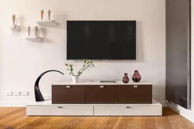 a living room with a flat screen tv on a wall at Mani San Domenico by DomuSicily in Palermo
