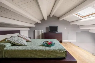 a bedroom with a bed and a television in a room at Mani San Domenico by DomuSicily in Palermo