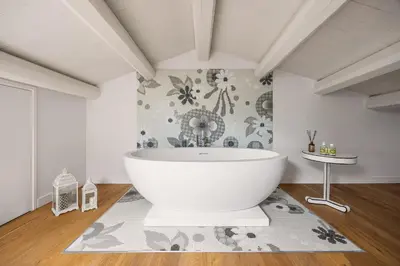 a bathroom with a large white tub in a room at Mani San Domenico by DomuSicily in Palermo
