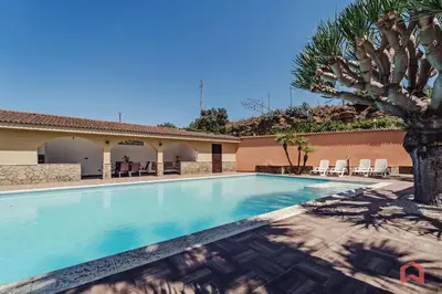 a swimming pool in a villa with a palm tree at Huge Villa with Stunnig Pool in Partinico