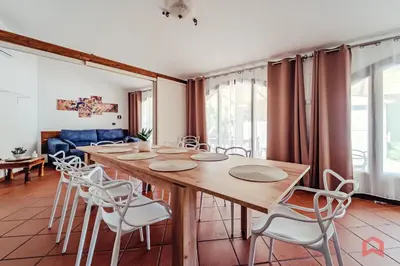 a dining room with a wooden table and chairs at Huge Villa with Stunnig Pool in Partinico