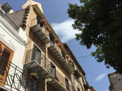 a building with balconies on the side of it at Casa Ballarò Centro Storico in Palermo
