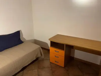 a bedroom with a desk with a bed and a desk sidx sidx sidx at Casa Ballarò Centro Storico in Palermo