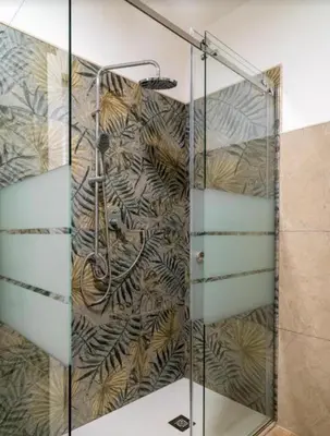 a shower with a glass door in a bathroom at Villa a due passi dal mare in Mandra Capreria