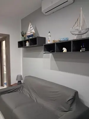 a bedroom with shelves on the wall with a bed at Stella Mare in Santa Flavia