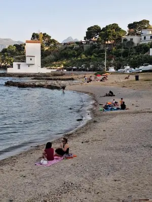 a group of people sitting on the beach at Stella Mare in Santa Flavia