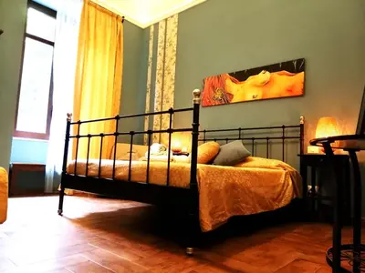 a bedroom with a bed and a painting on the wall at B&B Centro900 in Palermo