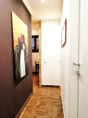 a hallway with a painting on the wall and a door at B&B Centro900 in Palermo