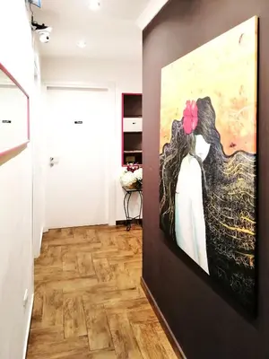 a hallway with a painting of a woman and a dog at B&B Centro900 in Palermo