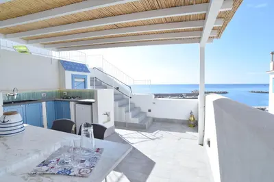 a balcony with a table and a view of the ocean at Re mare exclusive home in Terrasini