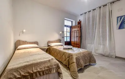 two beds in a room with a window at Villa Anastasia in Partinico