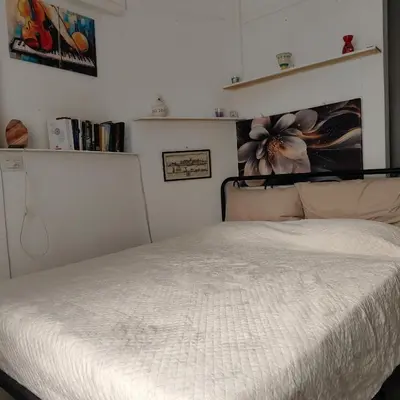 a bedroom with a bed with a white bedspread at Sedie Volanti Classy Home in Palermo