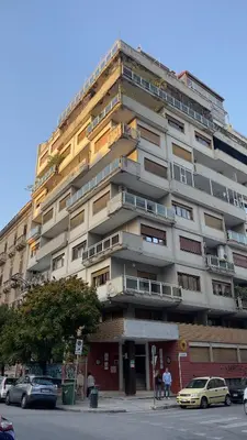 a tall building with cars parked in front of it at Villafranca33 - Politeama Centro Palermo in Palermo