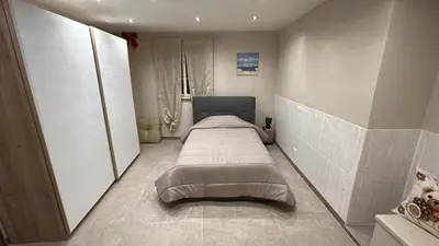 a bedroom with a bed in the corner of a room at Relax Home in Ficarazzi