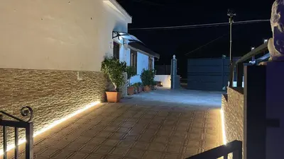 an empty street at night with plants in pots at Relax Home in Ficarazzi