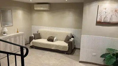 a living room with a couch in the corner at Relax Home in Ficarazzi