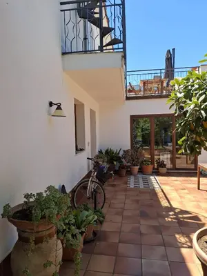 a bike parked next to a building with potted plants at Levriero1 in Carini