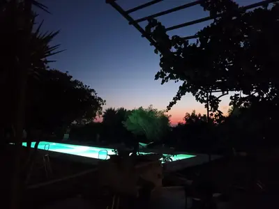 a swimming pool at night with the sun setting at Levriero1 in Carini