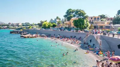 a group of people on a beach in the water at Villino Rosa in Santa Flavia