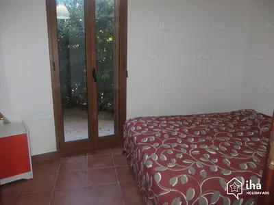 a room with a bed and a glass door at Villino Rosa in Santa Flavia