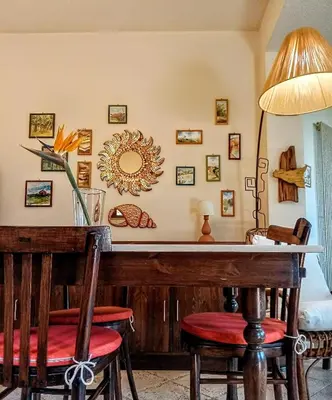 a dining room with a wooden bar with chairs at Sea View Holiday in Altavilla Milicia