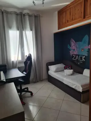 a bedroom with a bed and a desk and a chair at Casa Nadiia in Cinisi