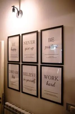 a group of five framed pictures on a wall at Marta's Home in Palermo