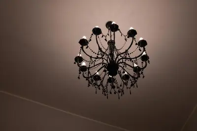 a black chandelier hanging from a ceiling at Marta's Home in Palermo