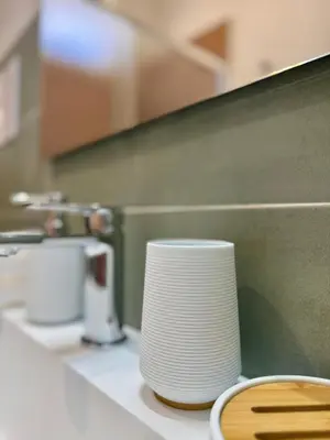 a stack of white plates sitting on a counter in a kitchen at TerrAmata in Terrasini