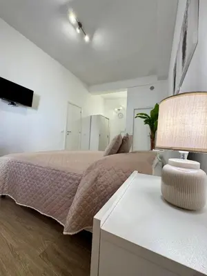 a bedroom with a bed and a table with a lamp at TerrAmata in Terrasini