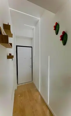 a hallway with a door and flowers on the wall at Suite 196 - Central City Palermo in Palermo