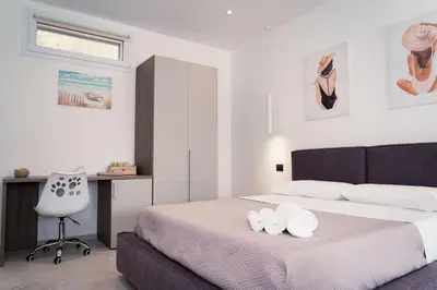 a bedroom with a bed with two towels on it at Acqua Marina Balestrate in Balestrate