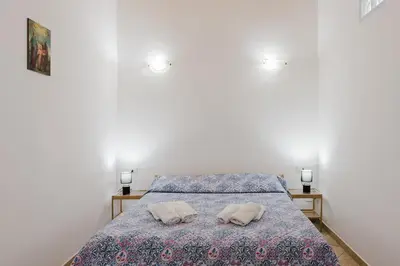 a bedroom with a bed and a tiled floor at Perla Marina in Trappeto