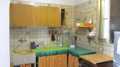 a kitchen with wooden cabinets and a green counter top at Da Sandra in Trabia