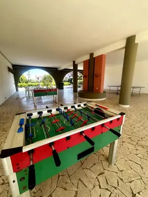 a ping pong table in the middle of a room at Casetta mia Seaside in Buonfornello