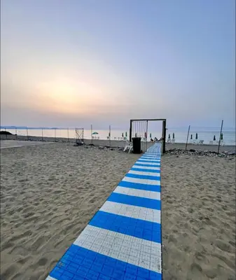 a blue and white path on a sandy beach at Casetta mia Seaside in Buonfornello