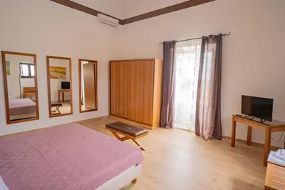 a bedroom with a bed and a tv and mirror at Himera Domus 2 in Termini Imerese