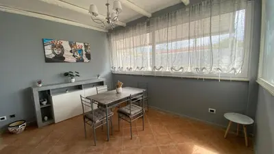 a dining room with a table and chairs and a window at La Casa Di Maria in Carini