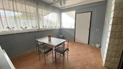 a dining room with a table and chairs at La Casa Di Maria in Carini