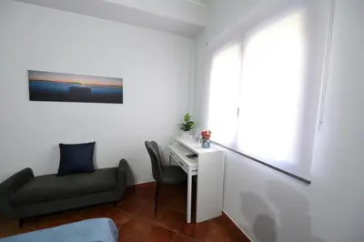 a small room with a desk and a chair at M&G Holiday House in Terrasini