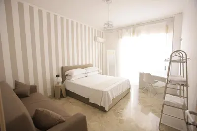 a bedroom with a bed and a ladder and a couch at Dream on the blue house Palermo in Palermo