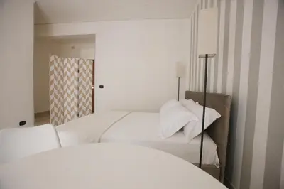 a bedroom with two beds with white sheets at Dream on the blue house Palermo in Palermo