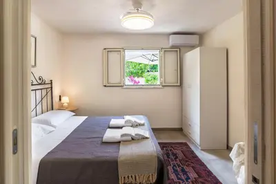 a small bedroom with a bed and a window at Casa Vacanze Villa Rosa Mondello in Palermo