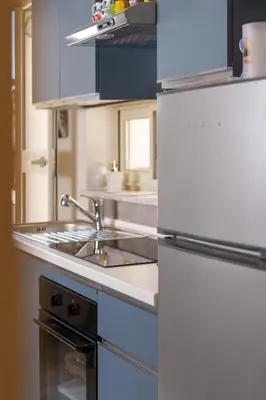 a kitchen with a white refrigerator and a sink at Casa Vacanze Villa Rosa Mondello in Palermo