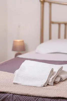 a pair of white towels sitting on a bed at Casa Vacanze Villa Rosa Mondello in Palermo