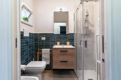 a bathroom with a toilet and a sink and a shower at Casa Vacanze Villa Rosa Mondello in Palermo