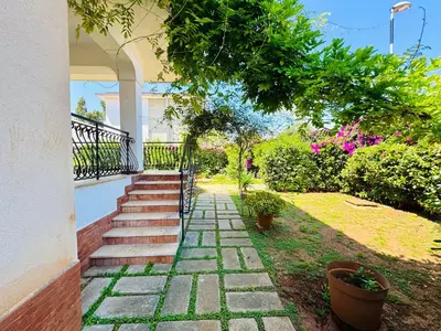 a kitchen with a door open to a living room at Villa Crilulù al Mare in Palermo