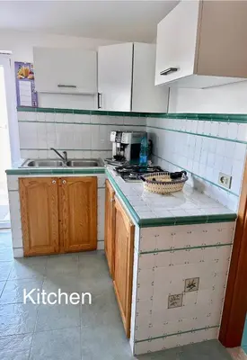 a kitchen with a sink and a stove top oven at Fantastic sea & harbour view Nino Bixio in Castellammare del Golfo