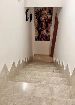 a stairway with a painting on the wall at Fantastic sea & harbour view Nino Bixio in Castellammare del Golfo
